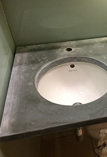 Westmoorland green slate vanity top with excessive limescale damage