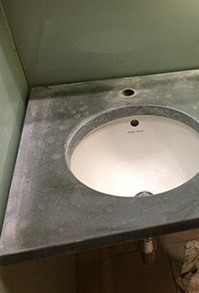Westmoorland green slate vanity top with excessive limescale damage